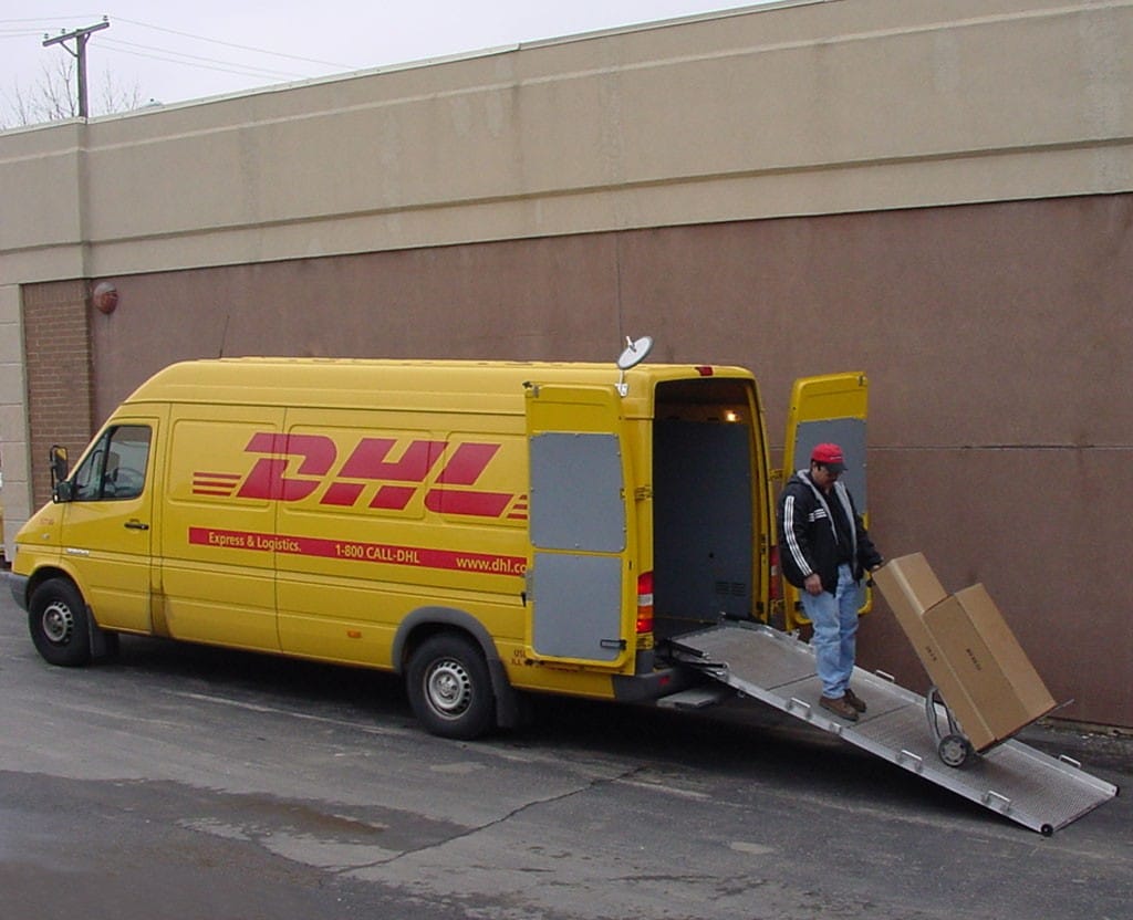 Person unloading a DHL truck using a sprinter van ramp