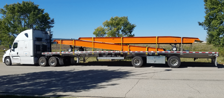 Two orange yard ramps on flatbed truck