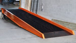 Industrial Toolz/Handiramp Yard Ramp for shipping positioned at an interior loading dock, ready to move product